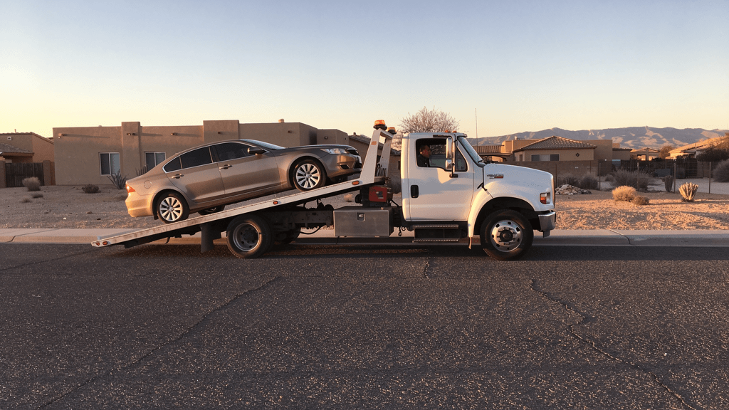 Flatbed tow truck loading a passenger vehicle